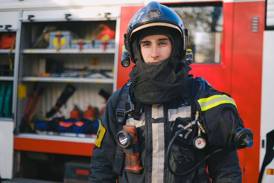 A firefighter in full turnout gear — third-hand smoke chemistry and take-home contamination